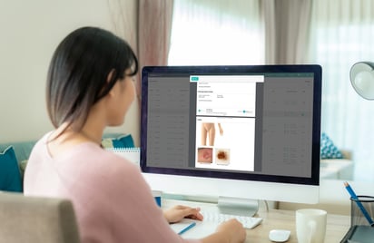 Doctor reviewing report on DermEngine